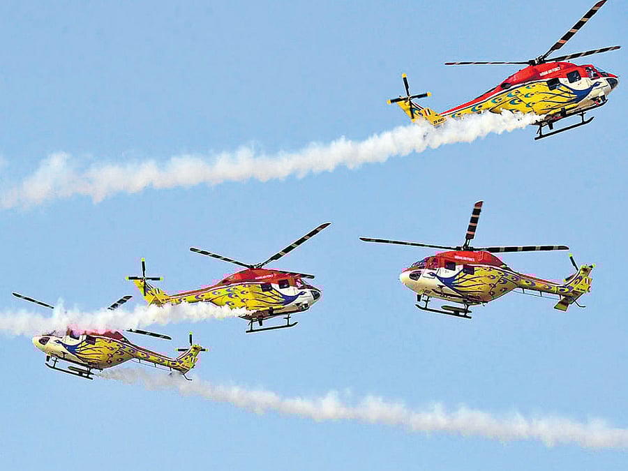 Sarang aerobatic teams perform at Yelahanka Air Force Station in Bengaluru on Thursday.DH photo by B K Janardhan & Kishor Kumar Bolar