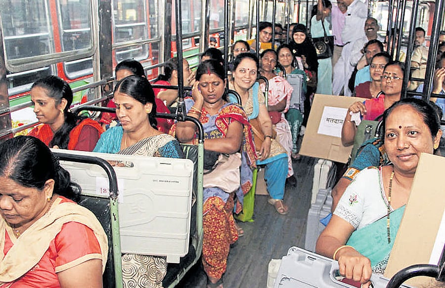 Officials carry electronic voting machines to their respective polling stations on Monday, on the eve of the BrihanMumbai Municipal Corporation elections. DH Photo