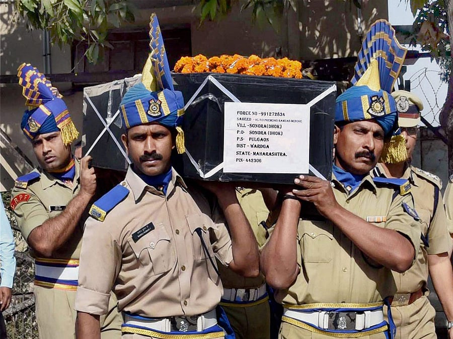 CRPF jawans carrying the coffin of H C Premdas Mendhe, killed in an ambush by Naxals in Sukma district of Chhattisgarh, at Nagpur Airport on Sunday. PTI Photo