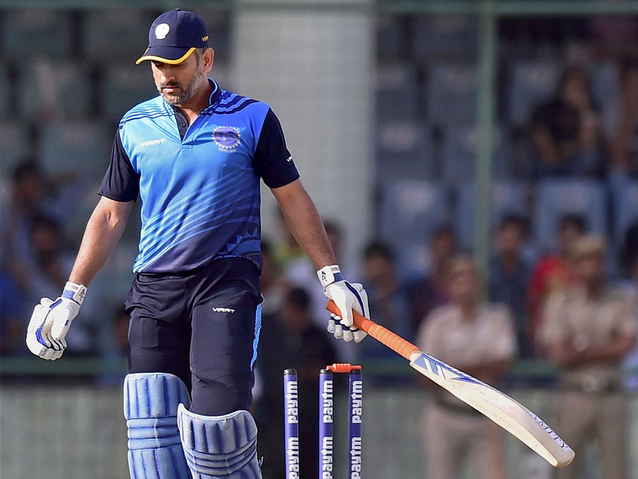 Jharkhand cricket captain M S Dhoni leaves after his dismissal during semi final of the Vijay Hazare trophy match in New Delhi on Saturday. PTI Photo