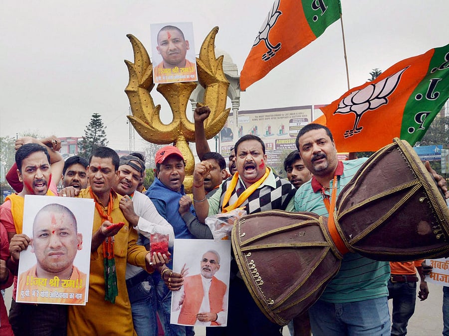 Bharatiya Janata Party workers celebrate the swearing-in of Yogi Adityanath as UP Chief Minister, in Patna on Sunday. PTI Photo