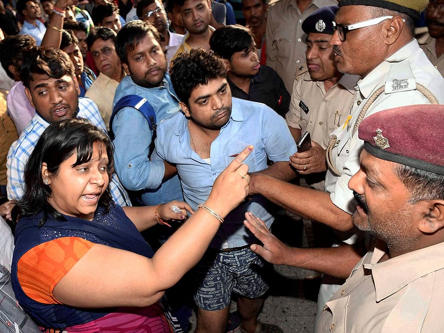 Robbery victims of New Delhi-Patna Rajdhani Express at Patna junction in Patna on Sunday. PTI Photo