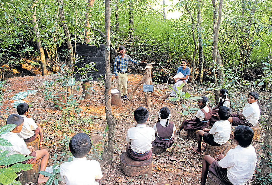 A learning session at Kalika Kaanu in Hudlamane village, Uttara Kannada district; (below) Balachandra Hegde Sayimane and G M Naik at the entrance of the green school. PHOTOS BY AUTHOR