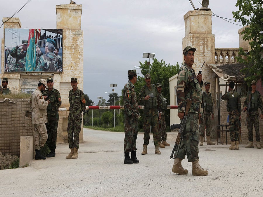 Afghan national Army (ANA) troops keep watch near the site of an ongoing attack on an army headquarters in Mazar-i-Sharif, northern Afghanistan April 21, 2017. REUTERS