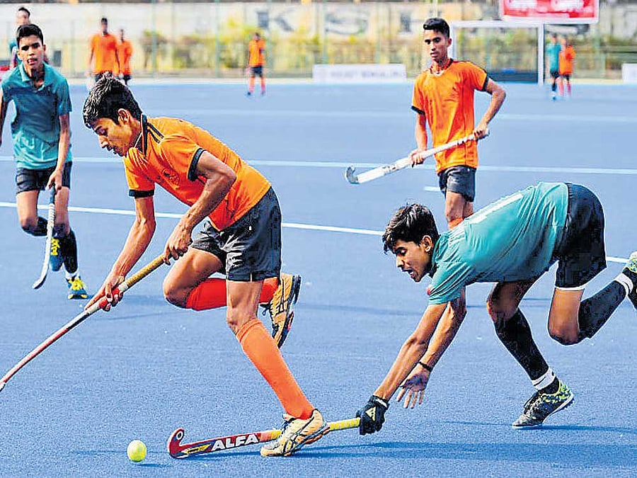 Keen tussle Chethan MK (left) of Hockey Coorg and Rehan Khan of Vidarbha Hockey Association vie for the ball at the Hockey stadium on Monday. DH Photo