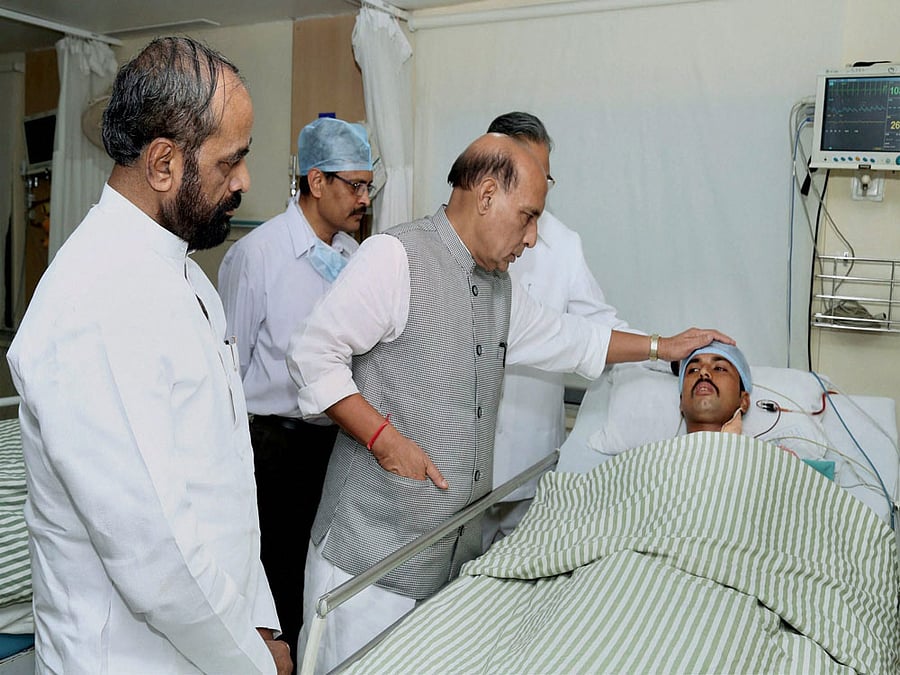 Union Home Minister Rajnath Singh enquiring about the health of injured CRPF personnel at the Ramkrishna Care Hospital, in Raipur, Chhattisgarh on Tuesday. Minister of State for Home Affairs Hansraj Gangaram Ahir is also seen. PTI Photo