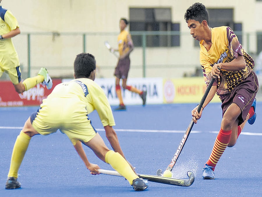Hockey Bengaluru's Umashankar (right) tries to get past Gulfun Han of Hockey Rajasthan. DH photo