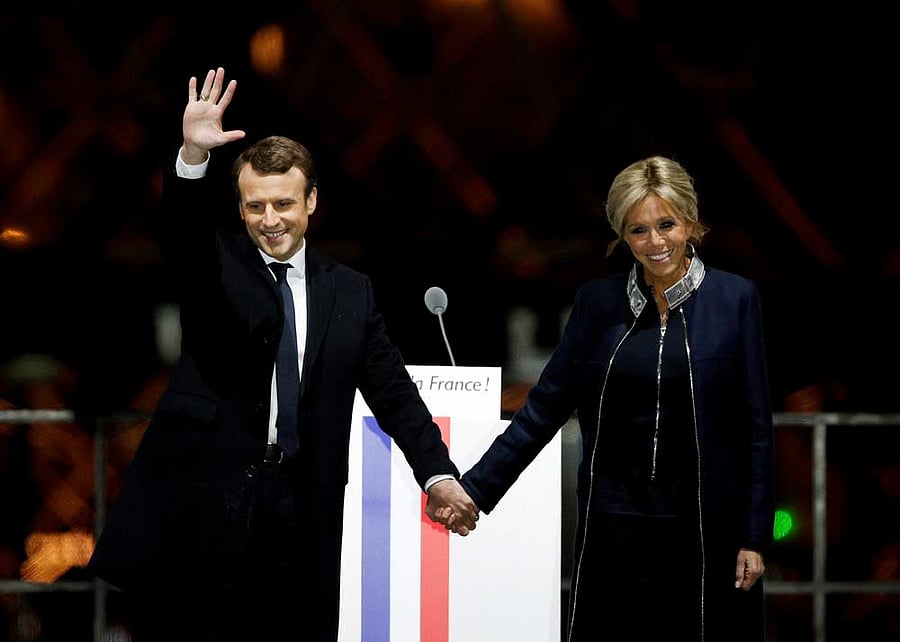French President-elect Emmanuel Macron holds hands with his wife Brigitte during a victory celebration outside the Louvre museum in Paris, France, Sunday, May 7, 2017. Speaking to thousands of supporters from the Louvre Museum's courtyard, Macron said that France is facing an 'immense task' to rebuild European unity, fix the economy and ensure security against extremist threats. AP/PTI