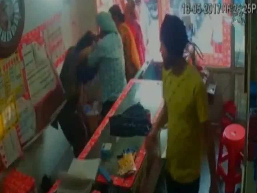 Hardip Singh and his wife, Kulwinder Kaur, were beaten up outside a shop in an area falling under Bhaini Mian Khan Police Station on May 13 and a video of the incident went viral on social media. Screengrab.