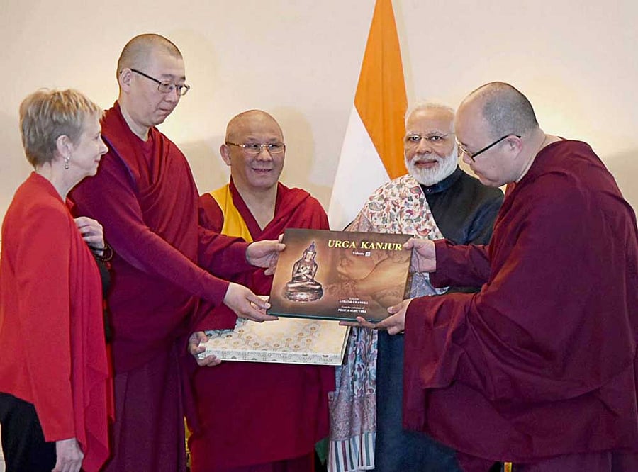 St. Petersburg: Prime Minister Narendra Modi presents over 100 volumes of Urga Kanjur to Jampa Donor, Buda Balzheivich Badmayev, Head Priest of Datsan Gunzechoinei Buddhist Temple in St Petersburg on Friday.PTI Photo