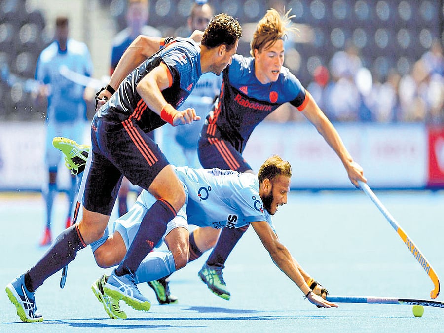 no way out: India's SV Sunil tries to get past the Netherlands defence during their Hockey World League Semifinals tie in London on Tuesday. PTI Photo