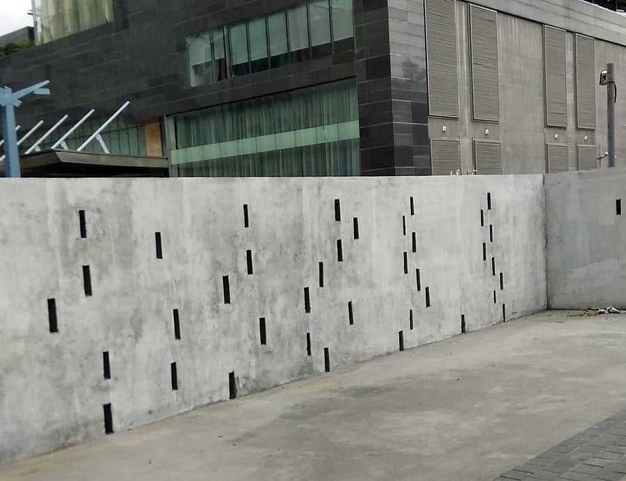 A wall built by Brigade Gateway to 'circumvent' the Supreme Court order that prohibits the sale of liquor within 500 metres of national highways. DH photo