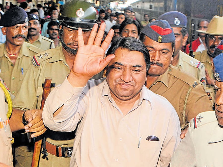 A file picture of stamp paper scam kingpin Abdul Karim Telgi being escorted by the police.