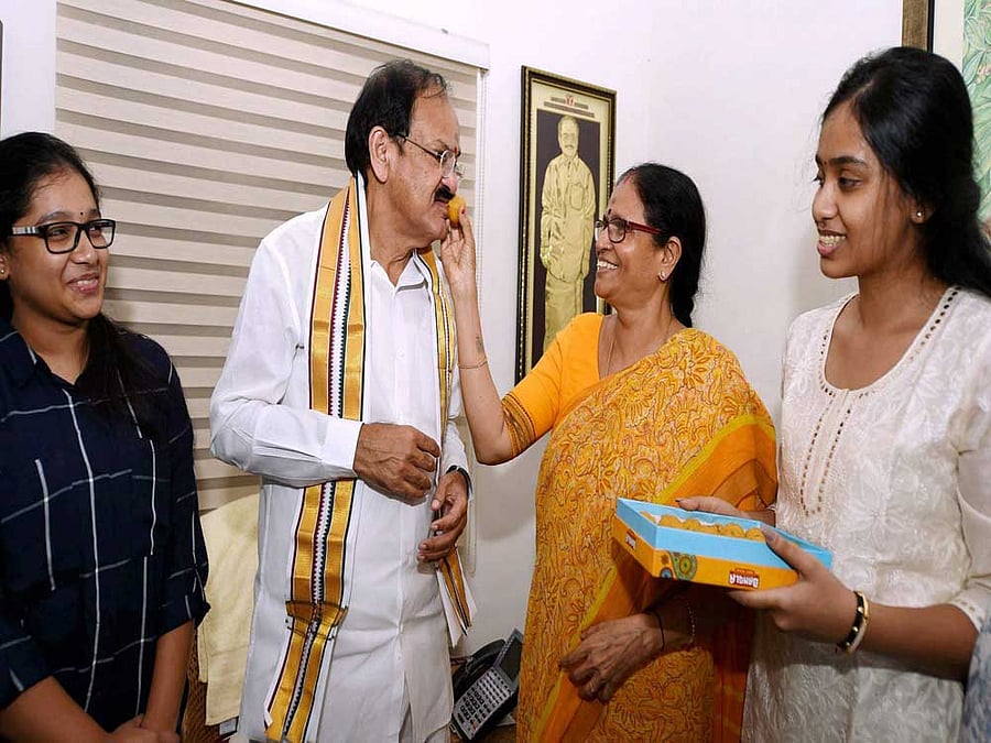Union Minister M. Venkaiah Naidu being offered sweets by his wife Usha and family members at his home, after he was announced as the NDA's Vice-Presidential candidate in New Delhi on Monday. PTI Photo