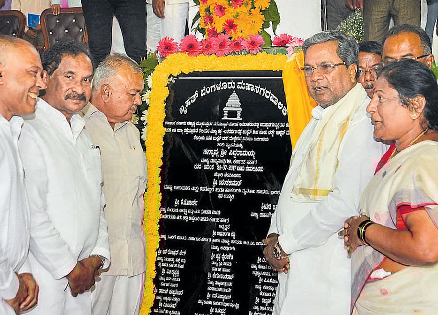 Chief Minister Siddaramaiah unveils the plaque after laying the foundation stone for a flyover in Koramangala on Monday. DH Photo