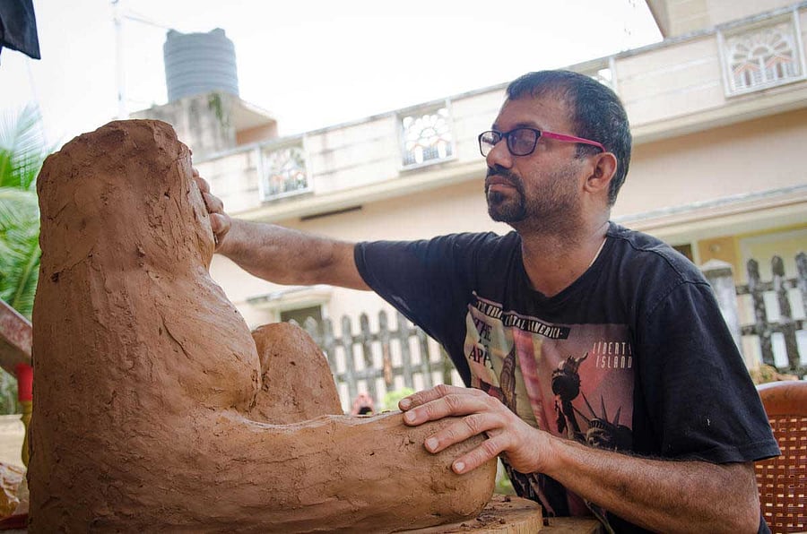 Venki Palimar making a clay sculpture