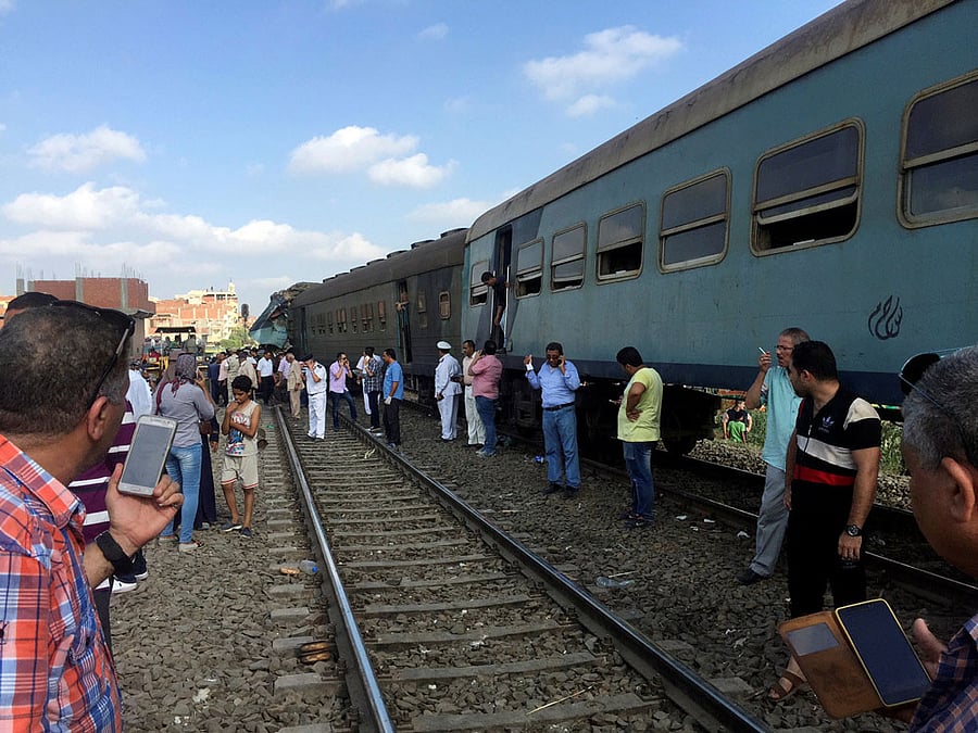 Egyptians look at the crash of two trains that collided near the Khorshid station in Egypt's coastal city of Alexandria, Egypt. Reuters.
