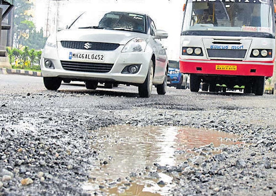 A badly damaged Tumakuru Road, off Gorguntepalya, following heavy rain. DH PHOTO