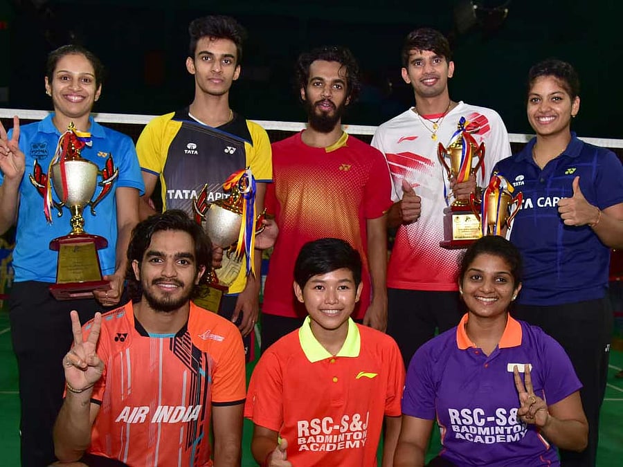 CHAMPIONS Winners in the All-India Senior-ranking badminton tournament at the Karnataka Badminton Association on Sunday. STANDING (from left): Neha Pandit (women's singles), Kiran George (men's singles), Arun George (men's doubles), Nanda Gopal K and Mahima Aggarwal (mixed doubles) KNEELING: Sanyam Shukla (men's doubles), Purnima Devi N, Sruthi K P (women's doubles). DH.