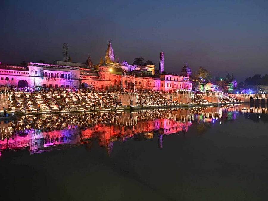 People lighting earthen lamps on banks of River Saryu during Deepotsav (Diwali celebrations) in Ayodhya on Wednesday. PTI Photo