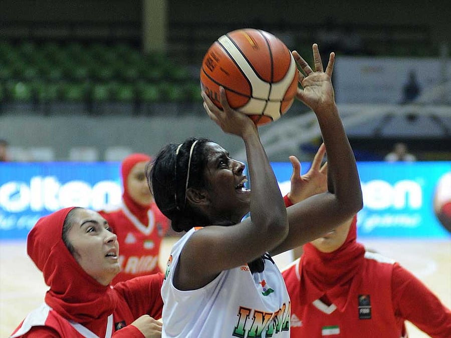 India' s Monica Jayakumar attempts to get past Iran's defenders during their clash at the Sree Kanteerava Stadium on Tuesday. DH PHOTO/ Srikanta Sharma R