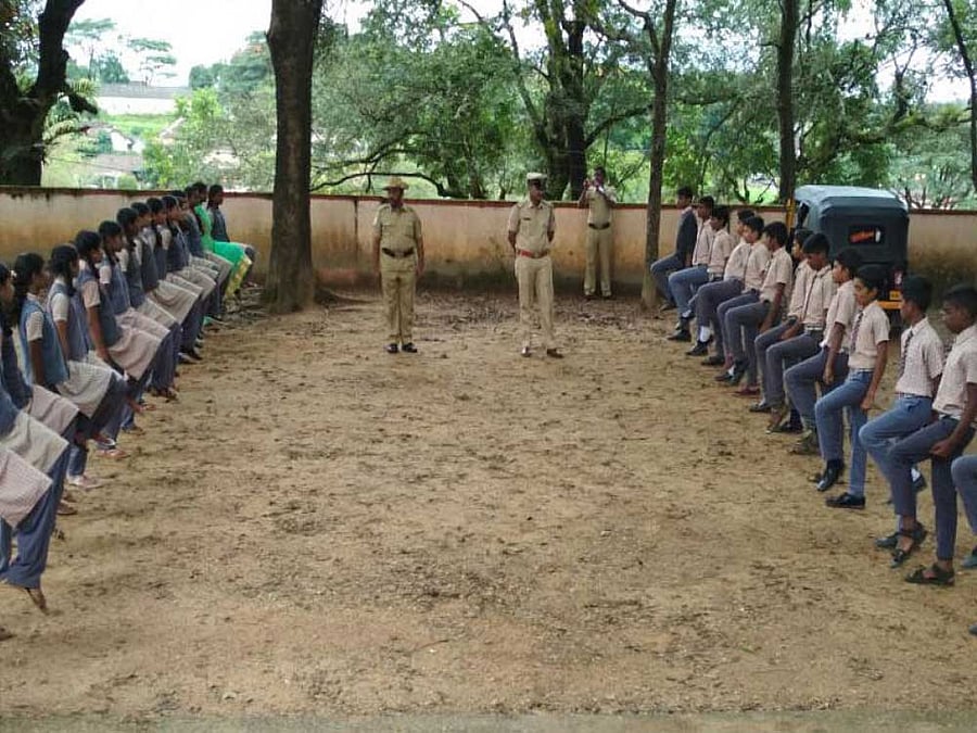 Police officers train students at a school as part of Student Police Cadet Programme.