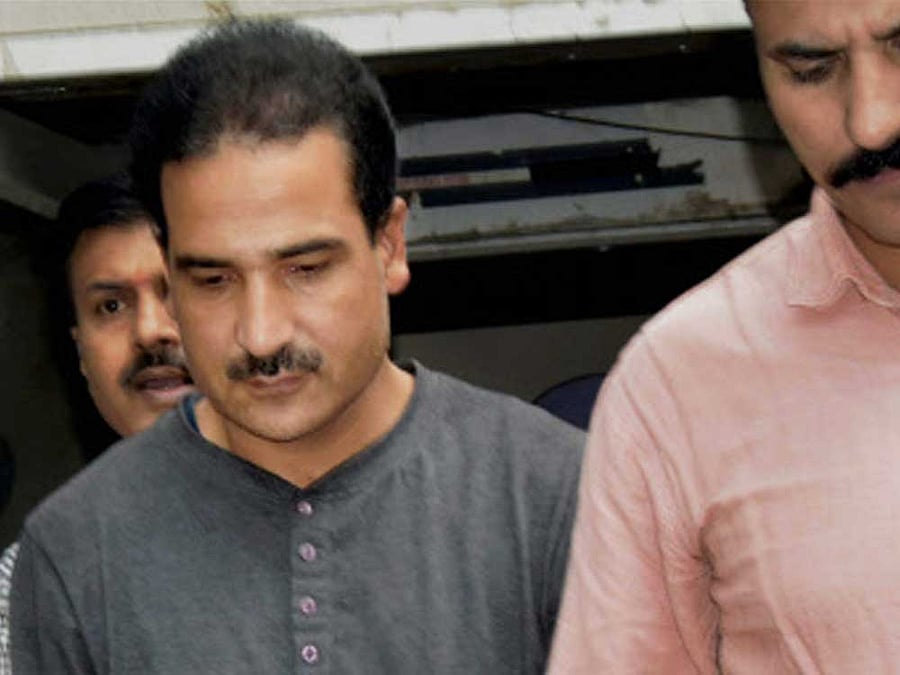 Globally wanted terrorist Syed Salahuddin's son Syed Shahid Yousuf, arrested by the National Investigation Agency in connection with terror funding case, being produced in a court at Patiala House Courts Complex in New Delhi on Wednesday. PTI Photo