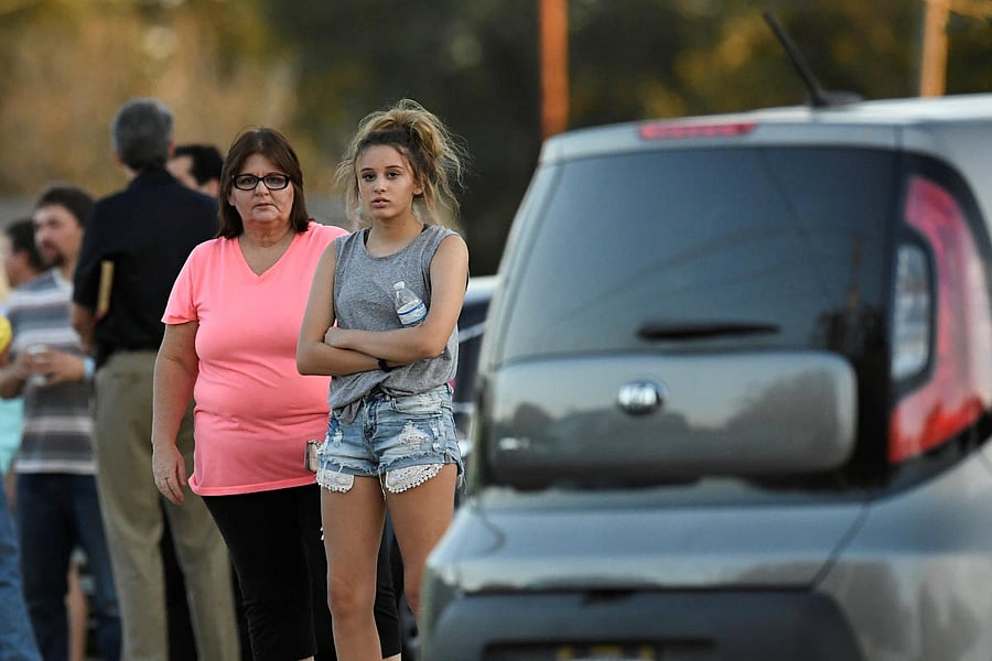 Local residents gather outside the Sutherland Springs Community Building after a mass shooting at the First Baptist Church in Sutherland Springs, Texas, US., November 5, 2017. REUTERS