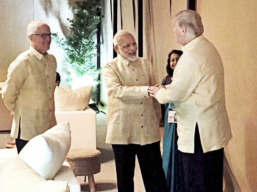 Prime Minister Narendra Modi shakes hands with US President Donald Trump during a meeting in Manila on Sunday. PTI Photo / Twitter