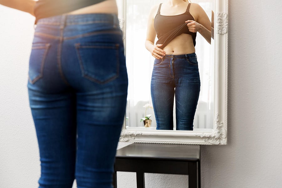 young fat woman looking at happy slim fit girl. Diet choice right nutrition healthy lifestyle concept
