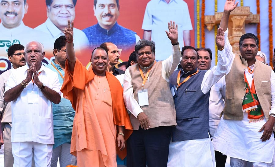 State BJP President B S Yeddyurappa, UP CM Yogi Adityanath, Jagadish Shettar, K S Eshwarappa, and Aravind Bellad greet the crowd at the BJP's Parivartana Yatre convention in Hubballi on Thursday.