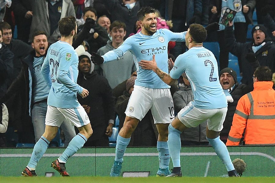 ON TARGET Manchester City's Sergio Aguero (centre) celebrates with teammates after scoring winner on Tuesday. AFP