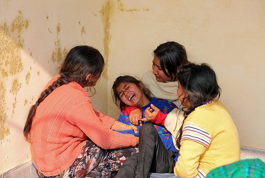A girl is consoled as she mourns the death of her father, who was reportedly killed by firing from the Pakistan side of the border on Sunday night, before his cremation at Kanachak in Akhnoor Sector on the outskirts of Jammu, on Monday. REUTERS