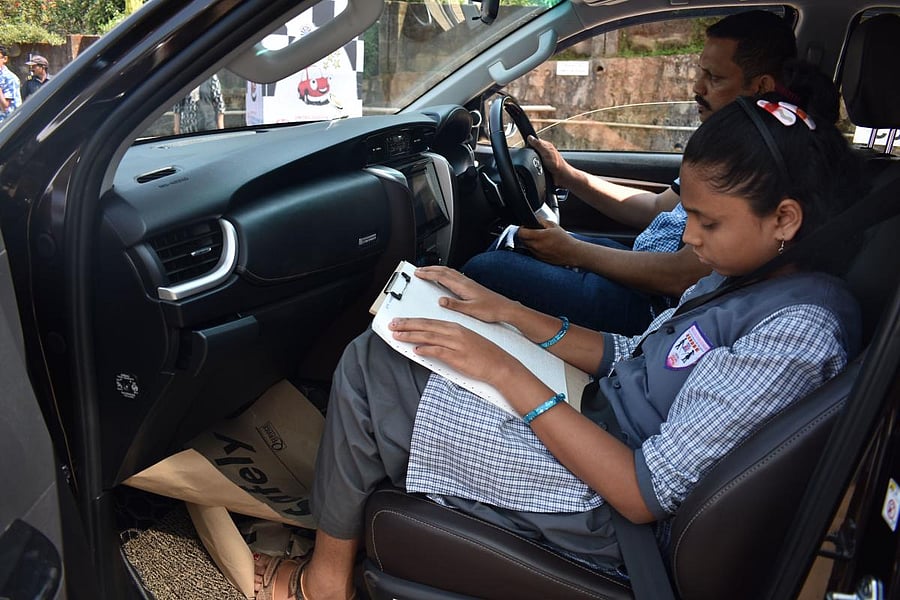 A visually challenged child reads the route map during the event.