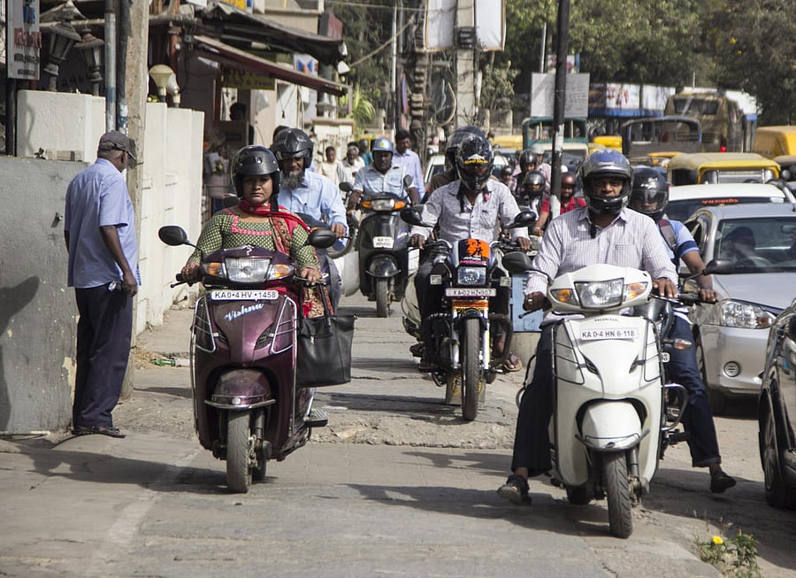 Bikers on Palace Guttahalli Road leave no space for pedestrians. DH PHOTO BY PRATHIKSHA