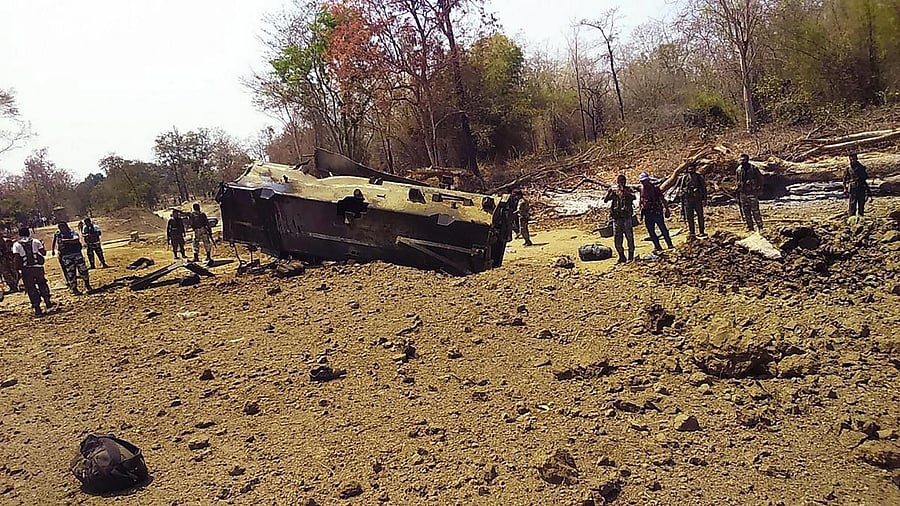 <div class="paragraphs"><p>Security personnel inspect the site of an IED blast. </p></div>