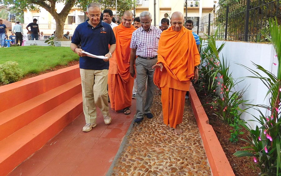 MLA J R Lobo, Swami Jitakamananda of Ramakrishna Mission and other dignitaries walk on Acupressure track at the renovated Arise Awake Park at Karangalpady.