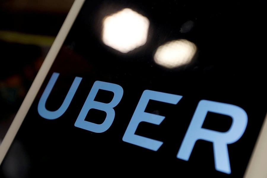 FILE PHOTO: The logo of Uber is seen on an iPad, during a news conference to announce Uber resumes ride-hailing service, in Taipei, Taiwan April 13, 2017. REUTERS/Tyrone Siu/File Photo