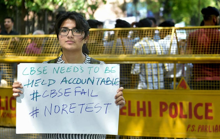 A 10th class Central Board of Secondary Education (CBSE) student displays a placard during a protest over the alleged paper leak, at Jantar Mantar in New Delhi. PTI Photo.