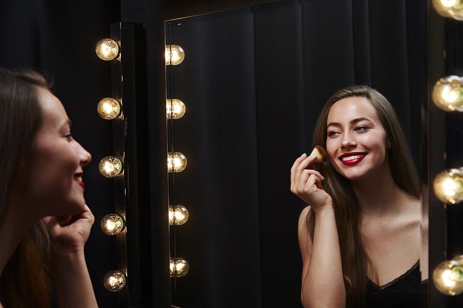 Portrait of a young woman in a dressing room with an evening party dress