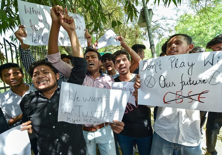 Central Board of Secondary Education students display placards during a protest over the paper leak, at Jantar Mantar in New Delhi. PTI