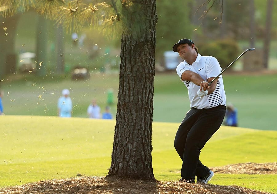 HARD PLAY American Patrick Reed hits from behind the tree during the second round of the Augusta Masters on Friday. AFP