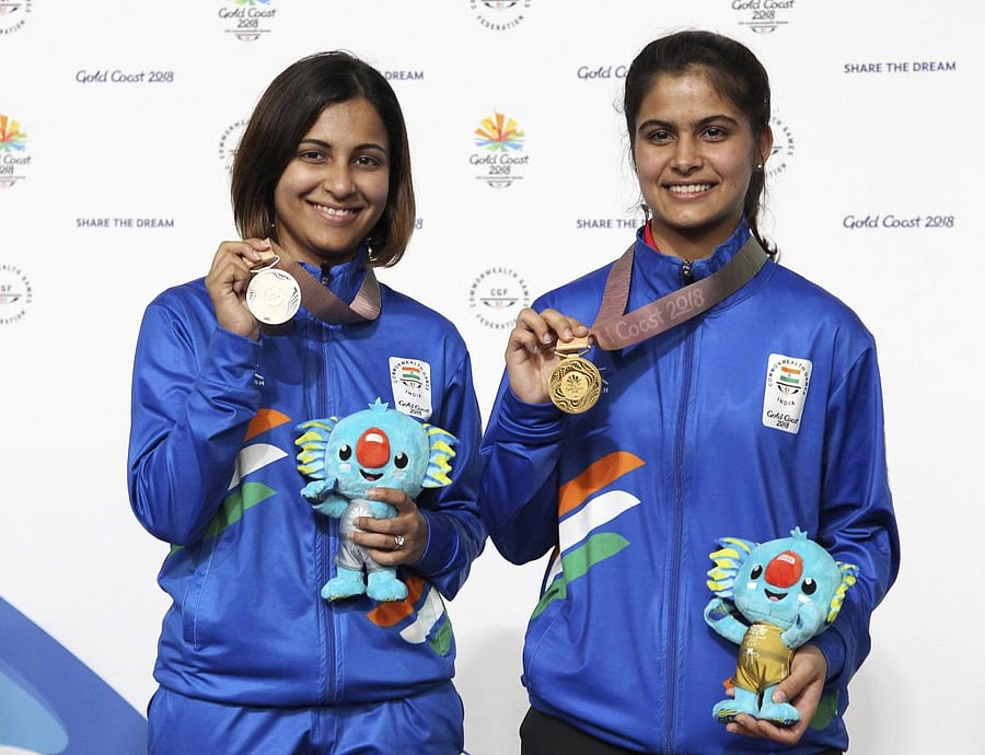 Gold medallist Manu Bhaker (right) and silver-winner Heena Sidhu at the medals ceremony of the women's 10m air pistol on Sunday. AP/ PTI