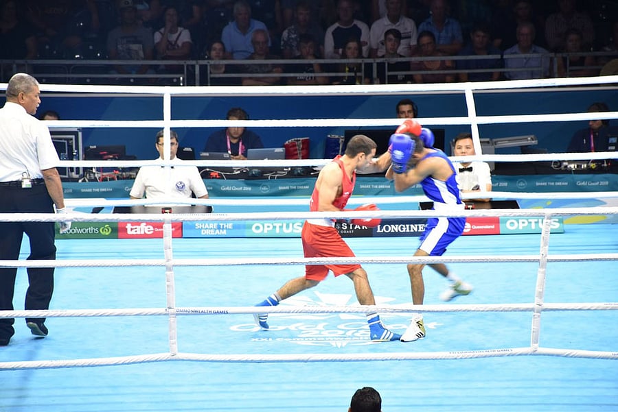 Amit Panghal lands a punch on Aqeel Ahmed. Twitter photo.
