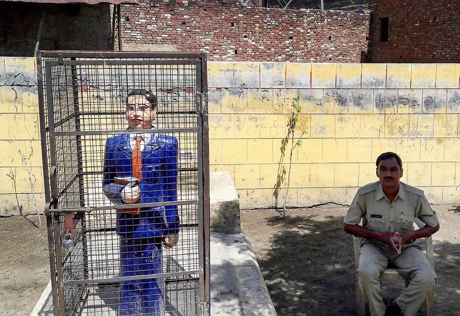 A statue of Dr Bhimrao Ambedkar locked in an iron cage, in Badaun on Thursday. PTI Photo