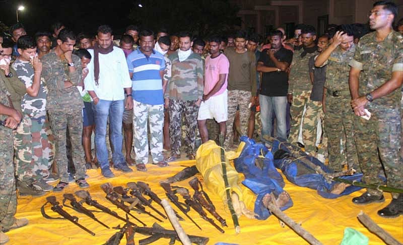 Photo from the encounter site. Army soldiers can be seen surrounding presumably Maoist bodies and seized arms.