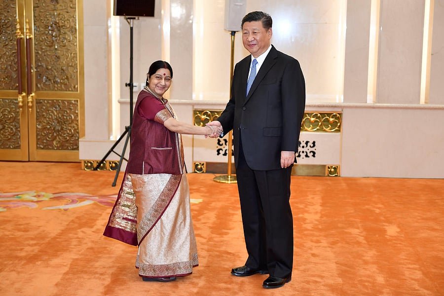 Indian Foreign Minister Sushma Swaraj shakes hands with Chinese President Xi Jinping before a meeting at the Great Hall of the People in Beijing, China April 23, 2018. (Naohiko Hatta/Pool via REUTERS)