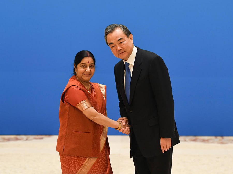 Indian Foreign Minister Sushma Swaraj (L) shakes hands with Chinese State Councilor and Foreign Minister Wang Yi before a meeting of foreign ministers and officials of the Shanghai Cooperation Organisation (SCO) at the Diaoyutai State Guest House in Beiji