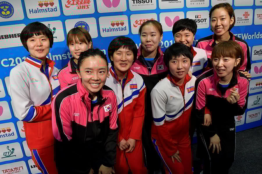South Korean and North Korean teams pose after deciding to form a unified Korean team for the semifinals at the World Team Table Tennis Championships in Sweden on Thursday. Reuters