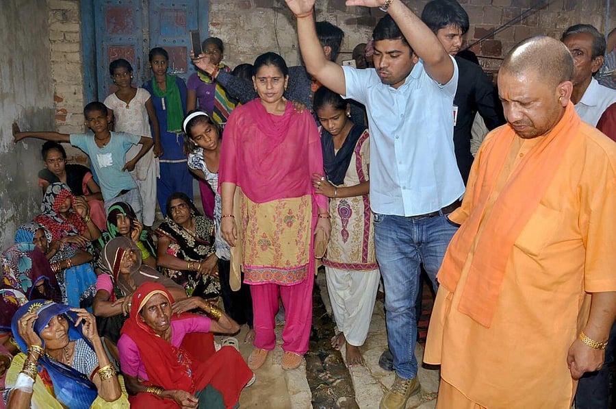Uttar Pradesh Chief Minister Yogi Adityanath meets the victims of Wednesday's storm, in in Mahua Khera on Saturday. PTI Photo